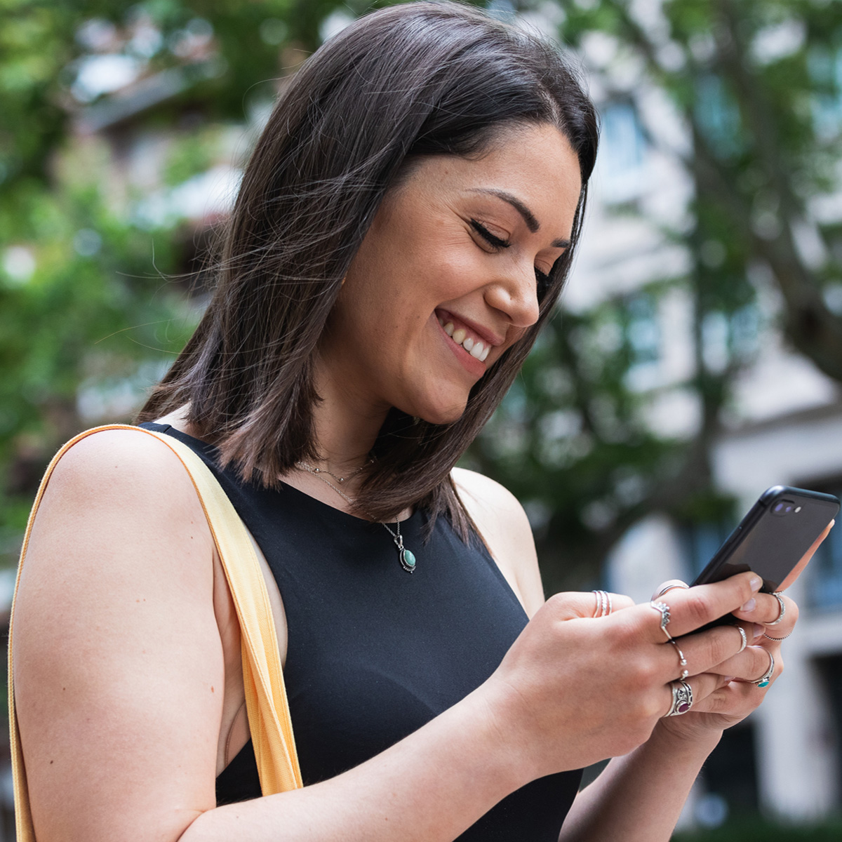 A woman checking her social media profiles on her smartphone